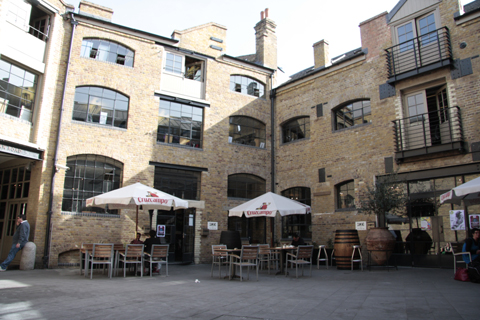 People enjoy a courtyard at Kings Cross Regents Quarter